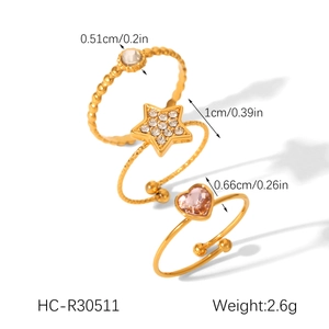 Three-piece gold titanium steel ring set featuring star, heart, and wave designs with zircons