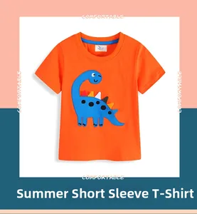 Detail of orange cotton kids T-shirt featuring a blue cartoon dinosaur embroidery