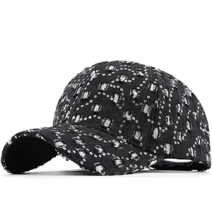 Distressed black denim baseball cap with silver sequin heart and star pattern