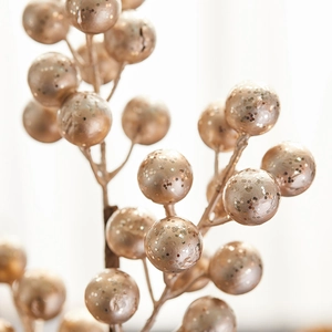 Glittering champagne gold berry branches for elegant Christmas floral decorations