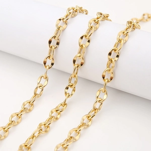Detailed macro view of 7mm golden stainless steel curb chain links on a white stand