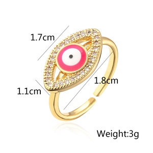 Macro shot of pink enamel evil eye ring with dimensions 1.7cm x 1.1cm and 3g weight