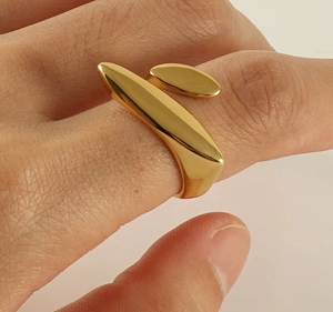 Detail shot of a minimalist 18k gold plated stainless steel irregular flowing ring