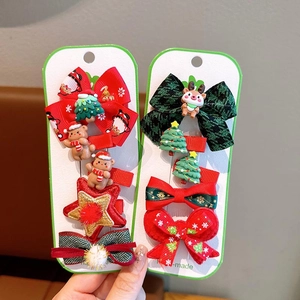 Christmas hair clip set featuring festive bows, snowmen, and reindeer on display cards