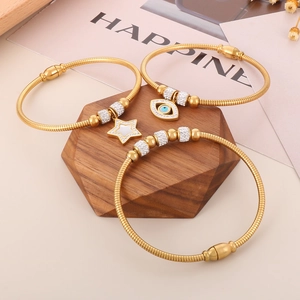 Three-piece gold snake chain bracelet set with evil eye and star charms for women