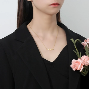 Close-up of elegant gold honeycomb smile necklace with diamonds on a model