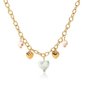 Gold chain necklace with blue ceramic heart and floral bead charms on white background