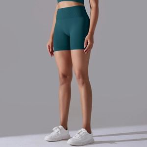Detail of high-waisted seamless dark green yoga shorts with ribbed compression waistband