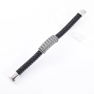 Macro view of woven black leather bracelet with industrial silver metal detailing