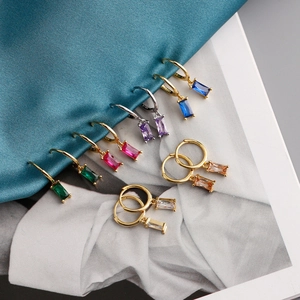 Detail showing s925 gold-plated huggie earrings with colorful rectangular zircons