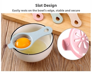 Close-up of a manual egg separator with side slot design fixed on a ceramic bowl