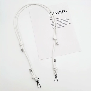 Detail view of adjustable white leather shoulder strap with durable metal clasps and knots