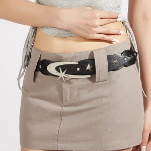 Close-up of black rivet belt with silver moon and star buckles in vintage punk style