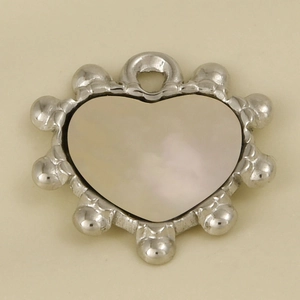 Detail of heart-shaped stainless steel pendant with white shell inlay and beaded edges