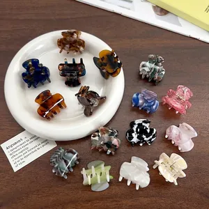 Mini acetate hair claws in various colors and marble patterns for women's hair styling