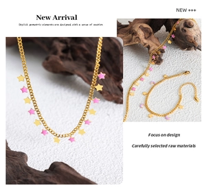 Detail of star and moon necklace and bracelet set in pink enamel and gold finish