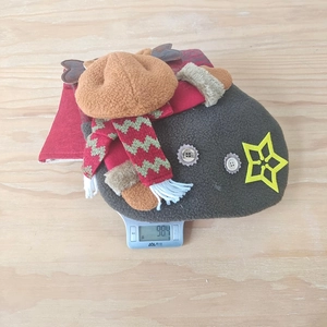Macro detail of large Christmas stocking weight measurement on scale showing 98.4g