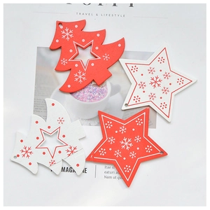 Detail of red and white wooden Christmas tree and star ornaments with snowflake print