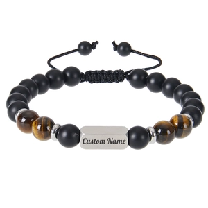 Detailed view of custom name engraving on tiger eye and matte onyx beaded bracelet