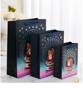 Three sizes of black Christmas gift bags with gradient foil and blue ribbon handles