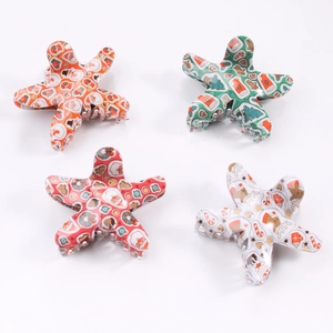 Star-shaped Christmas hair claws set with Santa and reindeer patterns on white background