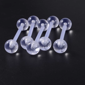Macro shot of five transparent acrylic barbell tongue rings on a dark reflective surface