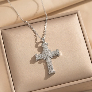 Elegant cross necklace with micro-paved zircons in a champagne jewelry box with silk ribbon