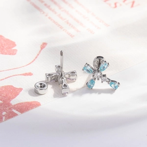 Micro-pave waterdrop zircon cross stud earrings in silver metal with light blue stones