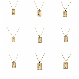 Detailed grid showing nine gold tarot pendants with micro-inlay engravings and crystals