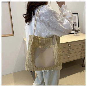 Detailansicht einer beigen Stroh-Tote-Bag mit Lederbesatz an einem weiblichen Model