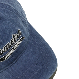 Detailed embroidery on navy corduroy baseball cap showing the slogan Advance Bravely