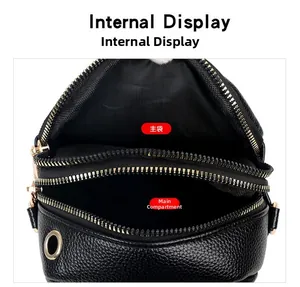 Internal display of black pebble leather crossbody bag with two main zipper pockets