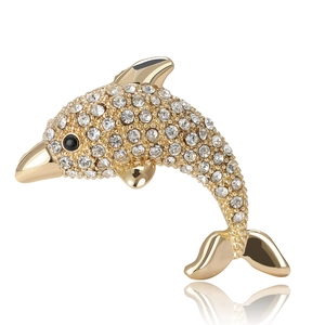 Elegant gold dolphin brooch with sparkling rhinestones and black gem eyes on white background
