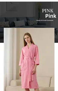 Detail of pink waffle weave bathrobe featuring soft fabric texture and large front pockets