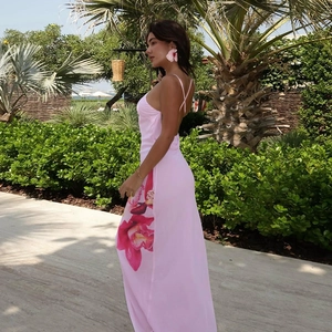 Detail of pink backless maxi dress featuring a large floral print on the side