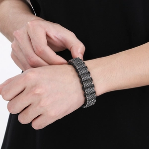 Detailed view of punk style braided leather bracelet with silver wire on male wrist