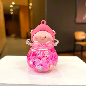 Detail of pink pig character in liquid drifting bottle with sparkling snowflakes