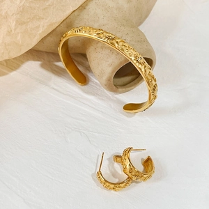 Golden stainless steel jewelry set featuring sun moon star motifs on ring and earrings