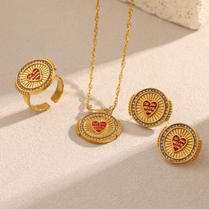 Detail of 18K gold-plated set with red heart disc engraving and zircon stones