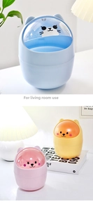 Close-up of cute cartoon mini desktop trash can with transparent lid for living room storage