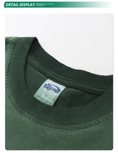 Detail of the crew neck and woven label on a washed dark green vintage cotton t-shirt