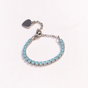 Detail of adjustable blue bead bracelet with silver heart pendant and pull-string closure