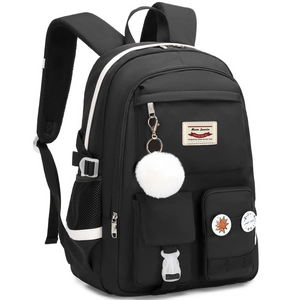 Detail of a black multi-pocket backpack featuring white pompom and decorative badges