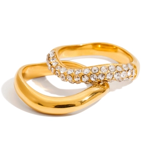 Detail of gold wave rings set featuring one polished band and one micro-pave crystal ring