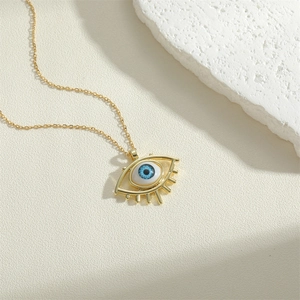 Chic gold-plated necklace with blue evil eye heart pendant on elegant white stone base