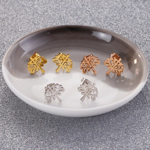 Detailed view of tree of life stud earrings in gold, silver, and rose gold finishes