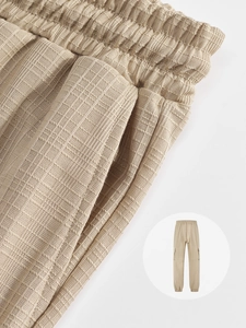 Detailed macro view of beige plaid linen texture and elastic drawstring waistband on trousers