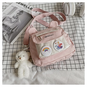Detail of pink canvas crossbody bag with cute bear ears and transparent badge window