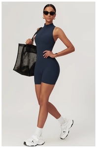 Detailed view of the sleek metal zipper on a high-support navy blue yoga romper