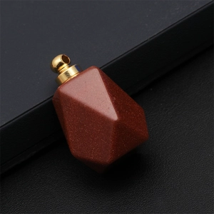 Macro shot of faceted goldstone perfume bottle pendant with a golden metal clasp